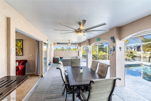 interior space with ceiling fan and glass enclosure