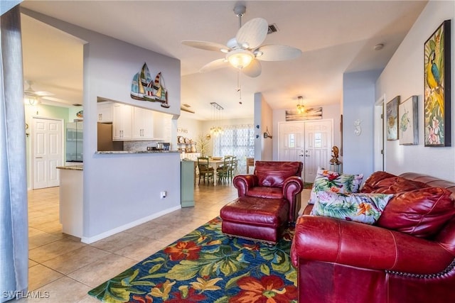 tiled living room with ceiling fan