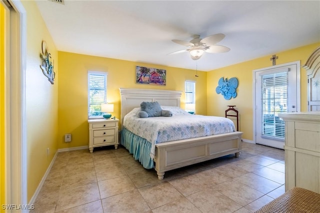 bedroom with ceiling fan, light tile patterned floors, access to exterior, and multiple windows