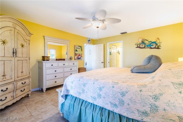 bedroom with ceiling fan and light tile patterned floors