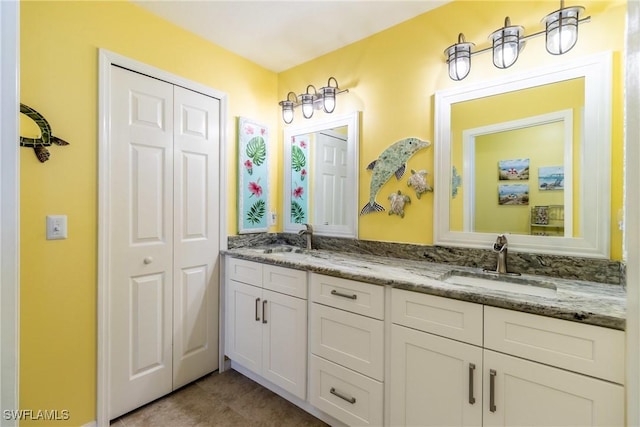 bathroom featuring tile patterned flooring and vanity