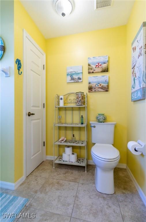 bathroom with toilet and tile patterned flooring