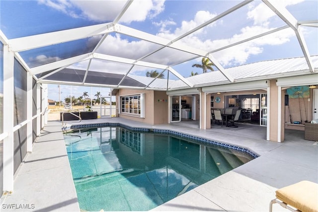 view of swimming pool with a patio and glass enclosure