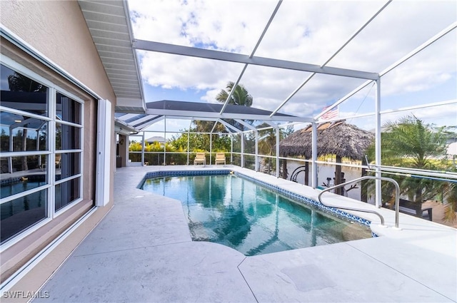 view of swimming pool with a lanai and a patio area