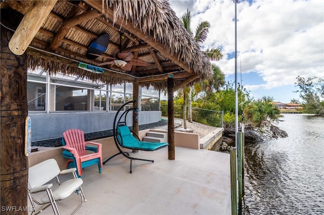 view of patio / terrace featuring a water view, a gazebo, ceiling fan, and a lanai