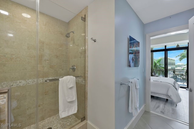 full bath with connected bathroom, a stall shower, and tile patterned floors