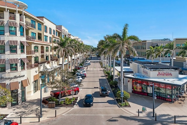 view of road with sidewalks, curbs, and street lighting