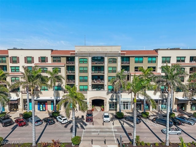 view of building exterior with uncovered parking