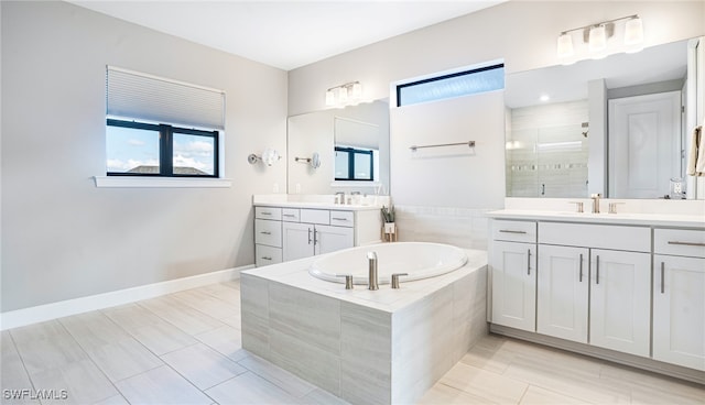 bathroom featuring vanity, shower with separate bathtub, and tile patterned floors