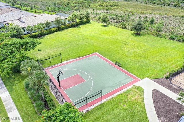 view of sport court featuring a yard