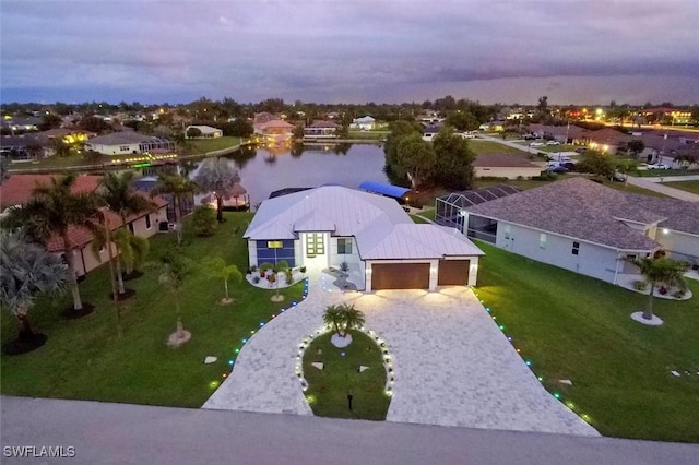 aerial view at dusk with a water view