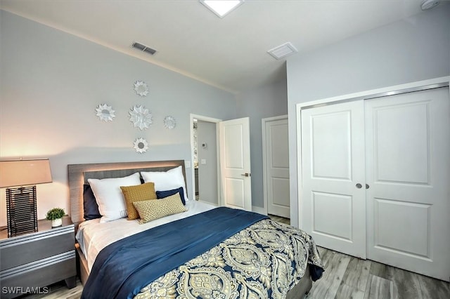 bedroom with light wood-type flooring and a closet