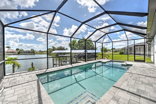 view of pool with a patio, a lanai, a yard, a water view, and a dock