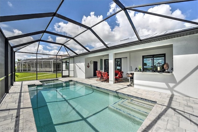 view of swimming pool with a lanai and a patio