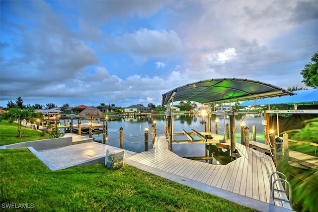 dock area featuring a lawn and a water view