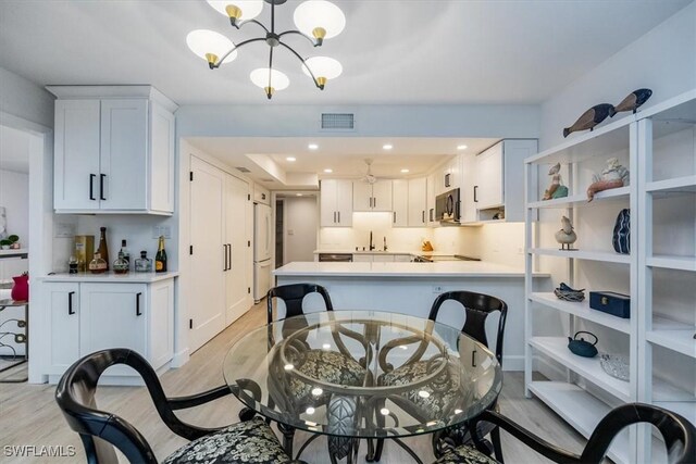 1772 Bald Eagle Dr Unit 504A, Naples, FL 34105 - dining space with light wood-style flooring, a chandelier, and recessed lighting