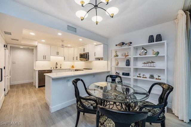 dining space featuring light wood-style flooring, visible vents, a notable chandelier, and recessed lighting