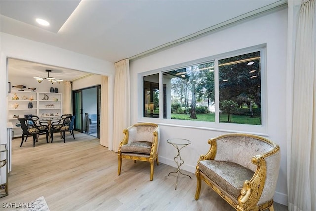 sitting room with baseboards and wood finished floors