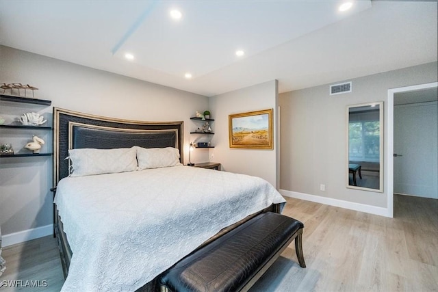 bedroom featuring recessed lighting, light wood-type flooring, visible vents, and baseboards