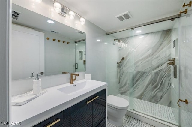 bathroom with a marble finish shower, vanity, and visible vents