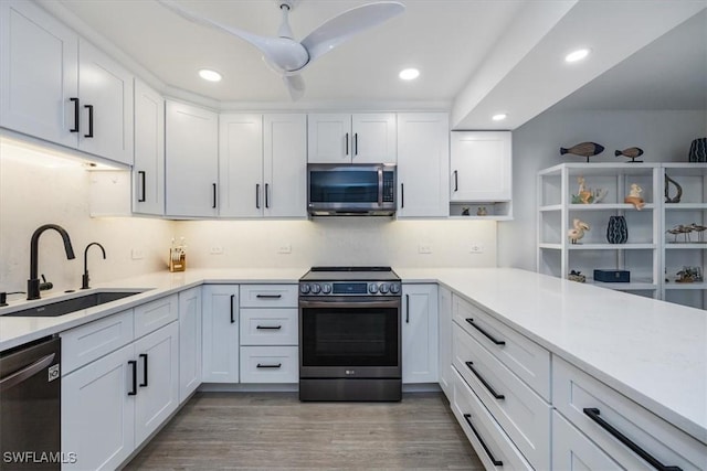 kitchen featuring white cabinets, stainless steel appliances, and light countertops