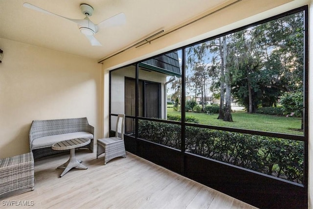 sunroom featuring ceiling fan