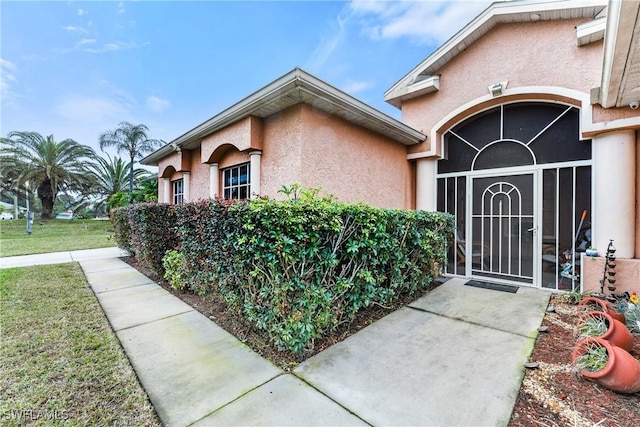 entrance to property with a yard