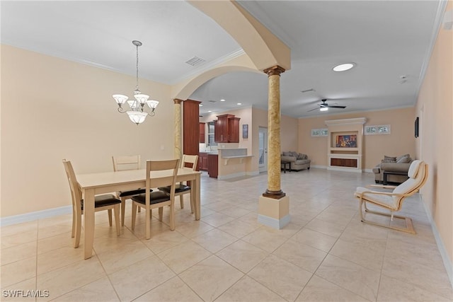 tiled dining space featuring ceiling fan with notable chandelier, ornamental molding, and ornate columns