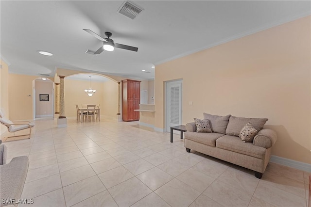 living room featuring ceiling fan with notable chandelier, light tile patterned floors, and ornamental molding