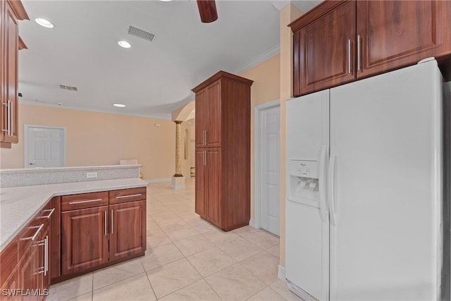 kitchen featuring white fridge with ice dispenser, ornamental molding, ceiling fan, light stone counters, and light tile patterned flooring