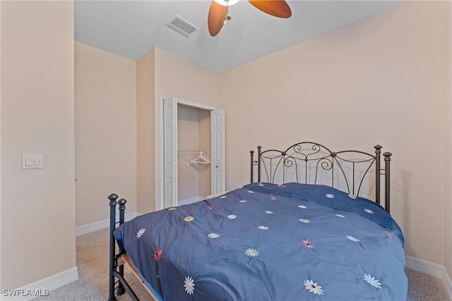 carpeted bedroom featuring a closet and ceiling fan