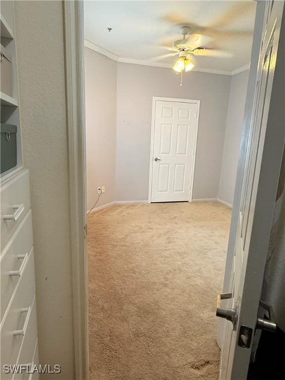 hall featuring ornamental molding and light carpet