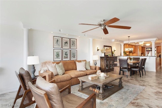 living room with ceiling fan, ornamental molding, and decorative columns