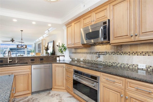 kitchen with sink, crown molding, dark stone counters, pendant lighting, and stainless steel appliances