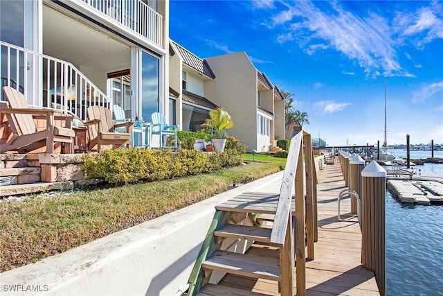 view of home's community featuring a water view and a dock