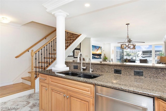 kitchen with sink, crown molding, decorative columns, and stone counters