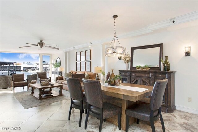 tiled dining area featuring ornamental molding and ceiling fan