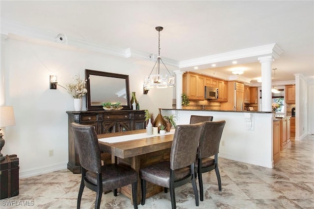 dining space featuring crown molding and ornate columns