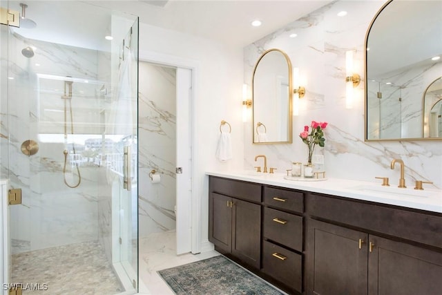 bathroom with vanity, a shower with shower door, and decorative backsplash