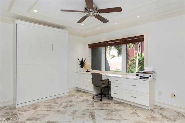 office space featuring a tray ceiling, crown molding, and ceiling fan