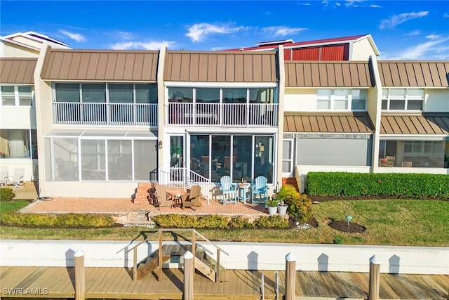 back of house featuring a sunroom and a patio area