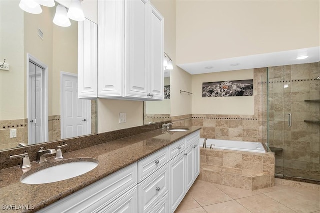 bathroom with vanity, independent shower and bath, and tile patterned flooring