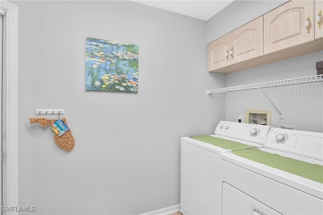 laundry room featuring cabinets and washer and clothes dryer