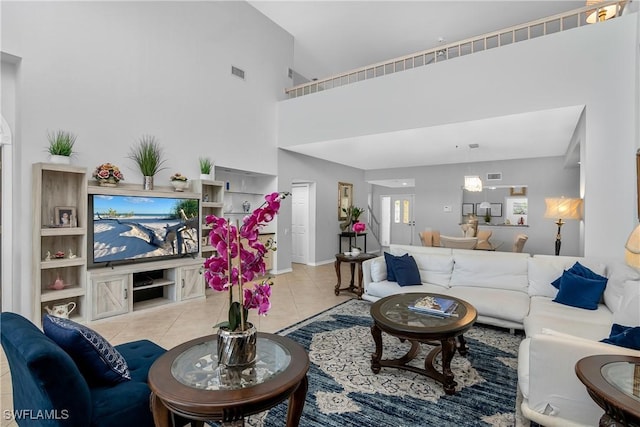 living room with light tile patterned flooring and a towering ceiling