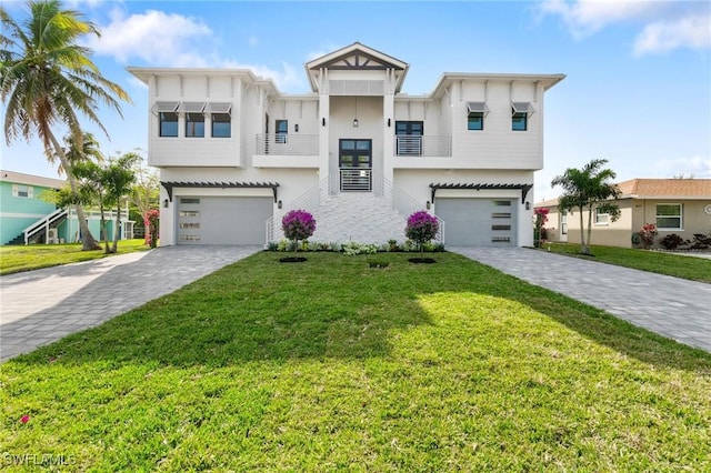 view of front of house with a garage and a front lawn