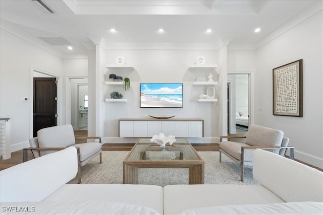 living room featuring crown molding and light hardwood / wood-style flooring