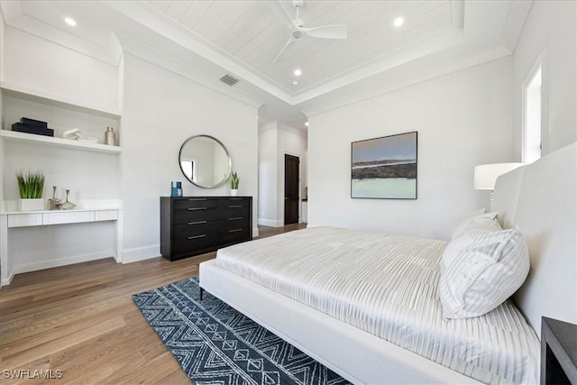 bedroom with wood ceiling, ceiling fan, crown molding, and wood-type flooring