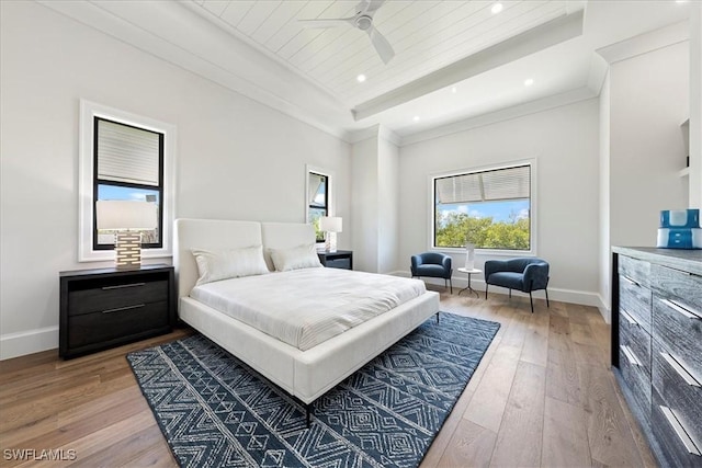 bedroom featuring ceiling fan, hardwood / wood-style floors, wooden ceiling, and crown molding