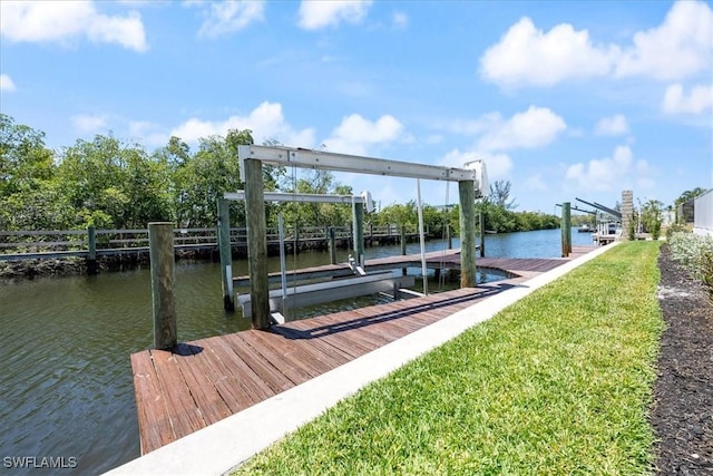 dock area featuring a lawn and a water view