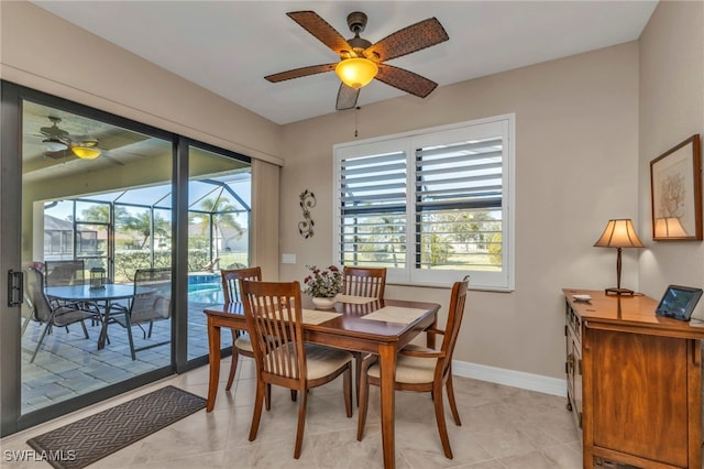 tiled dining space featuring ceiling fan